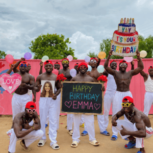 Pink Wall Team PLUS performing a personalized African birthday videos with custom name, photo, balloons, and birthday celebration message.