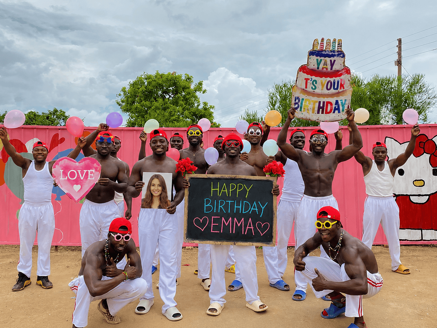 Pink Wall Team PLUS performing a personalized African birthday videos with custom name, photo, balloons, and birthday celebration message.