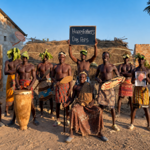 African Tribal Drummers Team performing a personalized Wishes From Africa video greeting with drums, traditional attire, custom message board, and recipient photo.